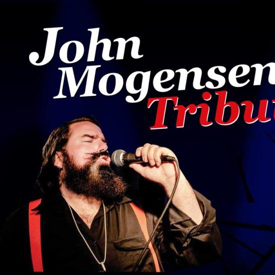 John Mogensen Tribute overskrift og en billede af sangere der synger under. 